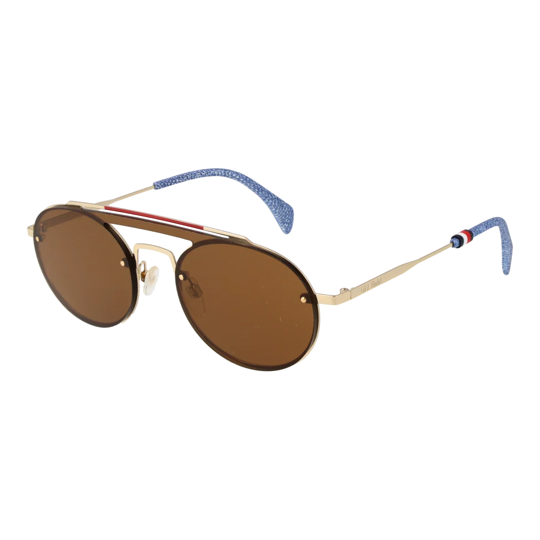 Tommy Hilfiger THF200 aviator sunglasses with gold frame and brown lenses on a Mediterranean rooftop